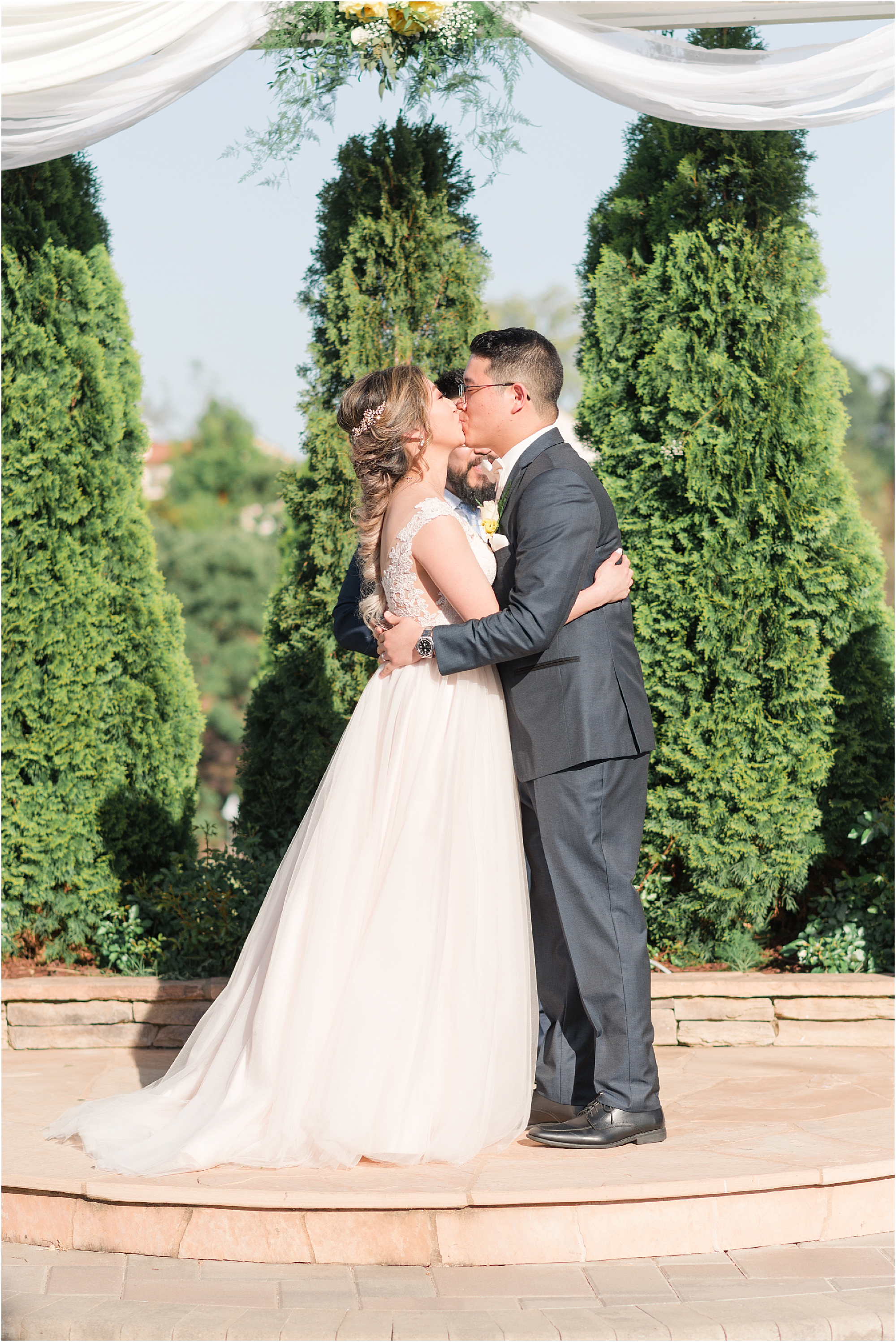 bride and groom first kiss in wedding in wine country