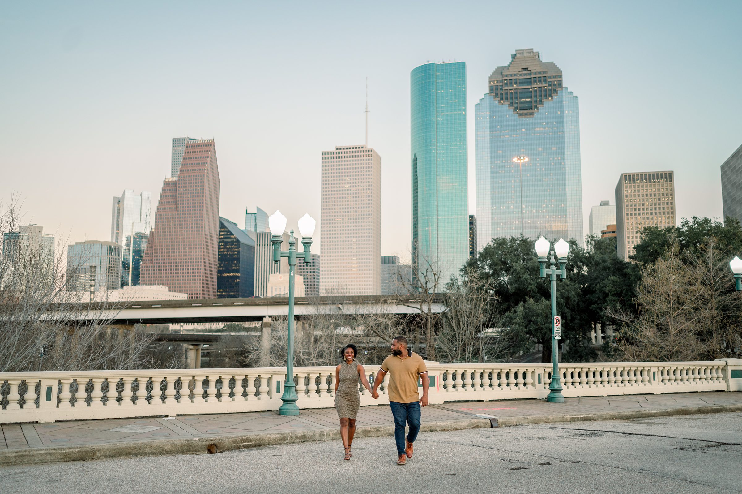 whiskey glasses and downtown bridge for their engagement session in Houston Texas