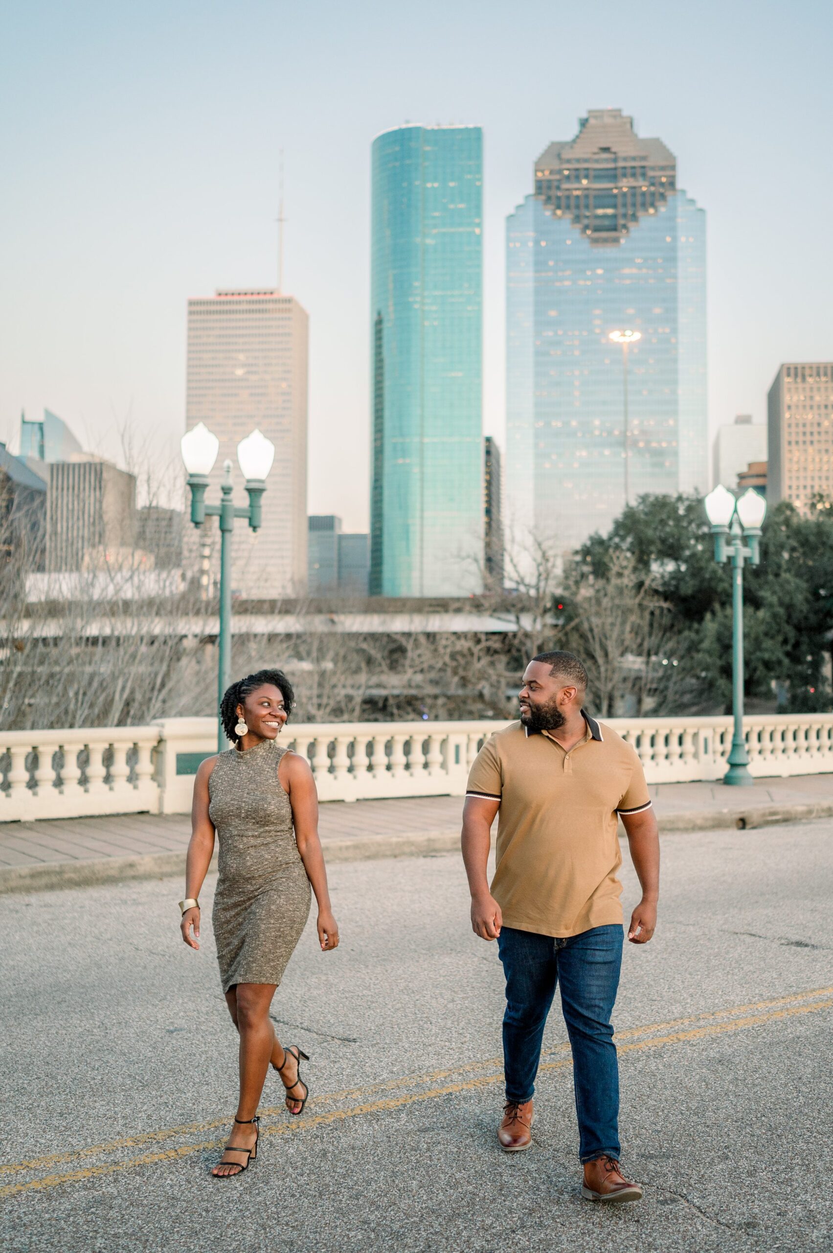 whiskey glasses and downtown bridge for their engagement session in Houston Texas