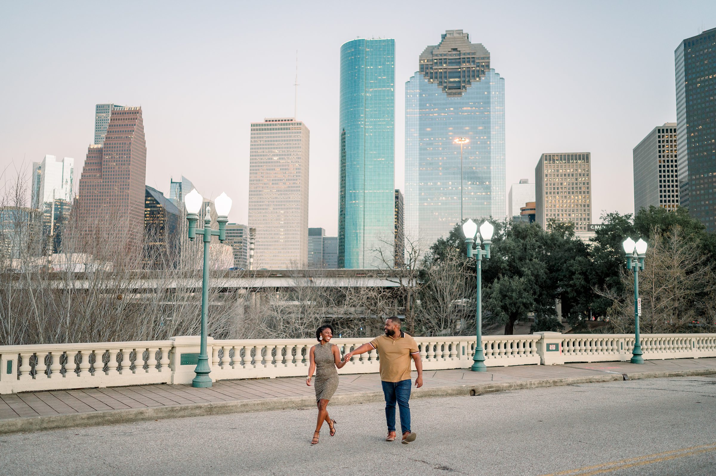 whiskey glasses and downtown bridge for their engagement session in Houston Texas